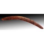 AN AUSTRALIAN ABORIGINAL WOODEN BOOMERANG with naive scratch carved decoration 59cm long