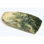 A MAORI GREENSTONE AXE HEAD of tapering form with natural striations 7.7cm long x 3.9cm wide at