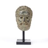 A BRONZE HEAD AFTER THE ANTIQUE of a Hirsute classical male subject on a square wooden plinth,