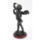 AFTER CLODION A bronze figure of a putti with hands held high and gripping drum beaters on rouge