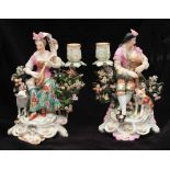 A PAIR OF DERBY FIGURAL PORCELAIN CANDLESTICKS one in the form of a lady playing a lute with sheep