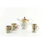 Dartington Pottery Tea set comprising teapot, milk jug, footed bowl and two cups painted with flower