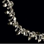 Brett Payne (British, Contemporary) Silver and 18ct gold collar necklace with repeating leaves,