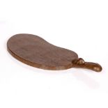 Robert Thompson of Kilburn (1876-1955) Mouseman cheese board oak, of kidney shape carved mouse