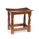Robert Thompson of Kilburn (1876-1955) Mouseman stool adzed oak, curved seat carved mouse