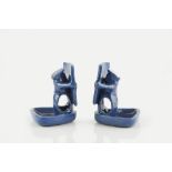 C. H. Brannam of Barnstaple Pair of napkin holders blue glaze, in the form of figures holding a