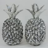A pair of silver painted pineapple ornaments,