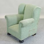 A 1920's children's green upholstered armchair