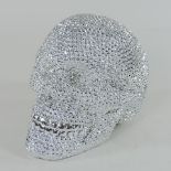 A silver coloured and diamante effect skull,