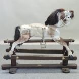 A painted wooden rocking horse, on a wooden rocker,