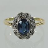 An 18 carat gold sapphire and diamond cluster ring,