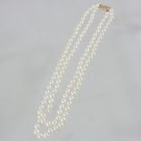 A pearl double strand necklace, with a 9 carat gold clasp,