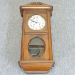 A 1920's walnut wall clock,