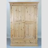 A pine double wardrobe, with a single drawer below,