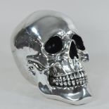 A decorative silver coloured model of a skull,