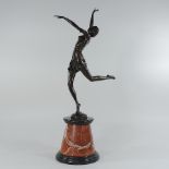 A bronze figure of a dancer, on a marble base,