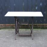 A cast iron sewing table with a marble top,