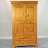 A modern pine double wardrobe, with drawers below,