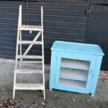 A blue painted cupboard, with a wire door,