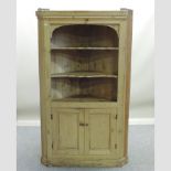A 19th century stripped pine standing corner cabinet,