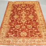 A Ziegler carpet, with all over foliate designs, on a red ground,