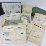 A collection of cigarette card albums and books