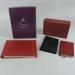 An Asprey address book, boxed, together with a Cartier notebook,