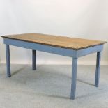 A blue painted and pine dining table,