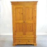 A modern pine double wardrobe, with drawers below,