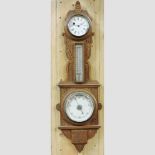A 20th century carved oak barometer,