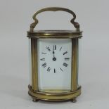A French brass cased carriage clock, with a white enamel dial,