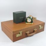 A Gucci gold plated and malachite stirrup shaped mantel clock, 9cm tall, boxed,