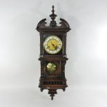 An early 20th century carved walnut drop dial wall clock,