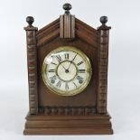 An early 20th century walnut cased mantel clock,