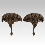 A pair of carved fruitwood wall brackets, in the form of birds,