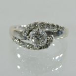 An 18 carat white gold diamond ring, of crossover design,