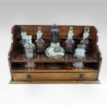 A 19th century mahogany apothecary stand, containing seven various glass jars, with a drawer below,