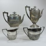 An Edwardian four piece silver tea and coffee service, of half gadrooned oval shape,