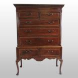 An 18th century mahogany and chevron strung chest on stand, with a dentil moulded cornice,