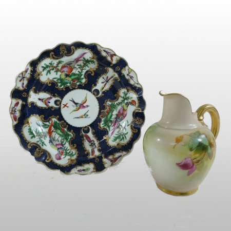 An 18th century Worcester porcelain cabinet plate, reserved with panels of exotic birds,