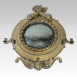 A large Regency carved pine and gilt gesso frame convex wall mirror,