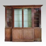 An unusually large 19th century mahogany break front library bookcase, having a moulded cornice,