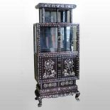 An ornate Chinese rosewood and mother of pearl inlaid display cabinet,