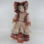 A bisque headed doll, possibly by Kammer and Reinhardt, impressed 192/13,