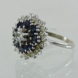 An 18 carat white gold sapphire and diamond tiered cluster ring,