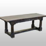 A 17th century style oak refectory dining table, the three plank top with cleated ends,