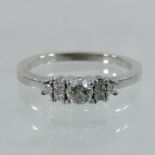 A platinum and diamond seven stone ring, the central stone flanked by six smaller,