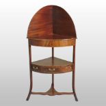 A George III mahogany and boxwood strung corner washstand, on a splayed base,