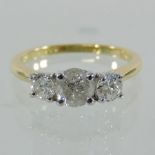 An 18 carat gold and platinum set three stone diamond ring, approximately 1.