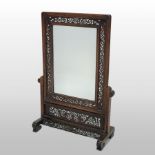 An early 20th century Chinese carved rosewood table screen, with fret carved decoration,